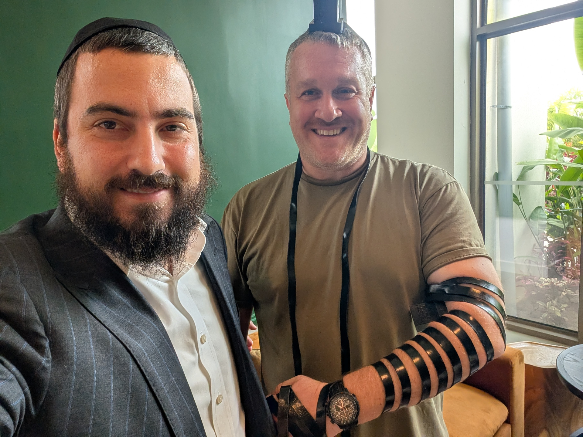 Putting on tefillin with a community member